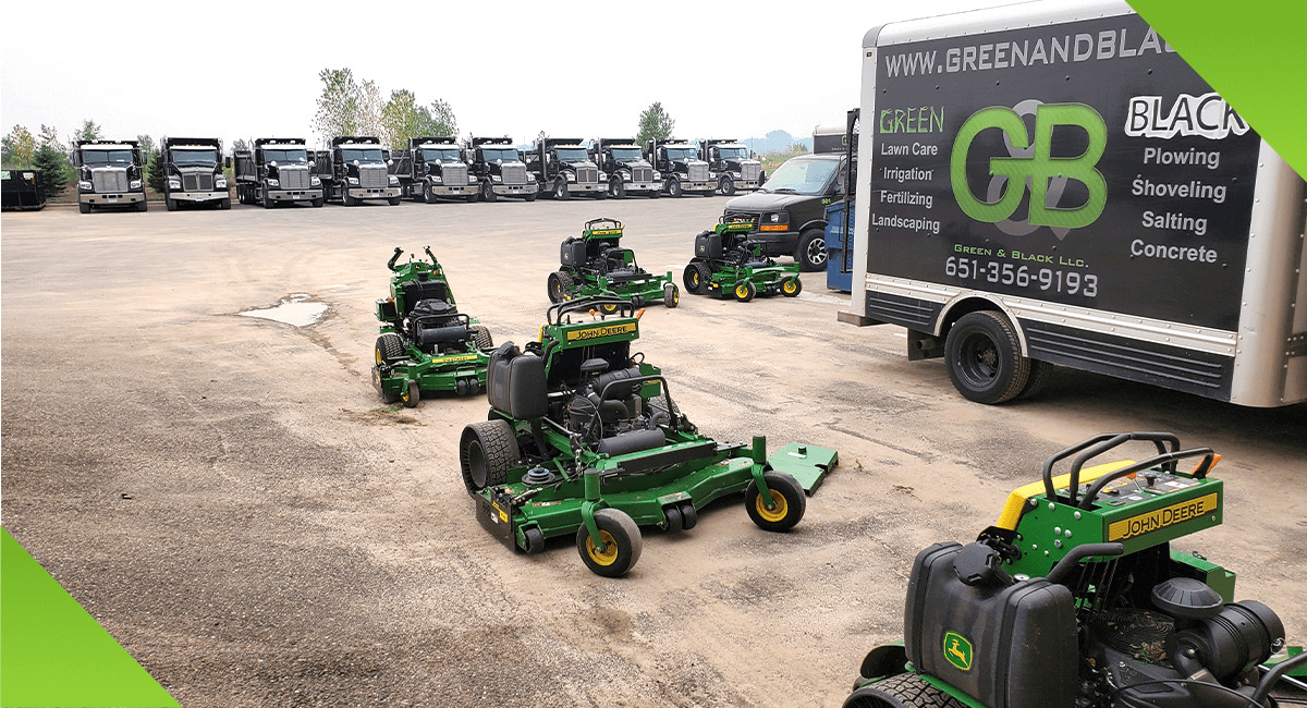Green and Black trailer, trucks, and mowers
